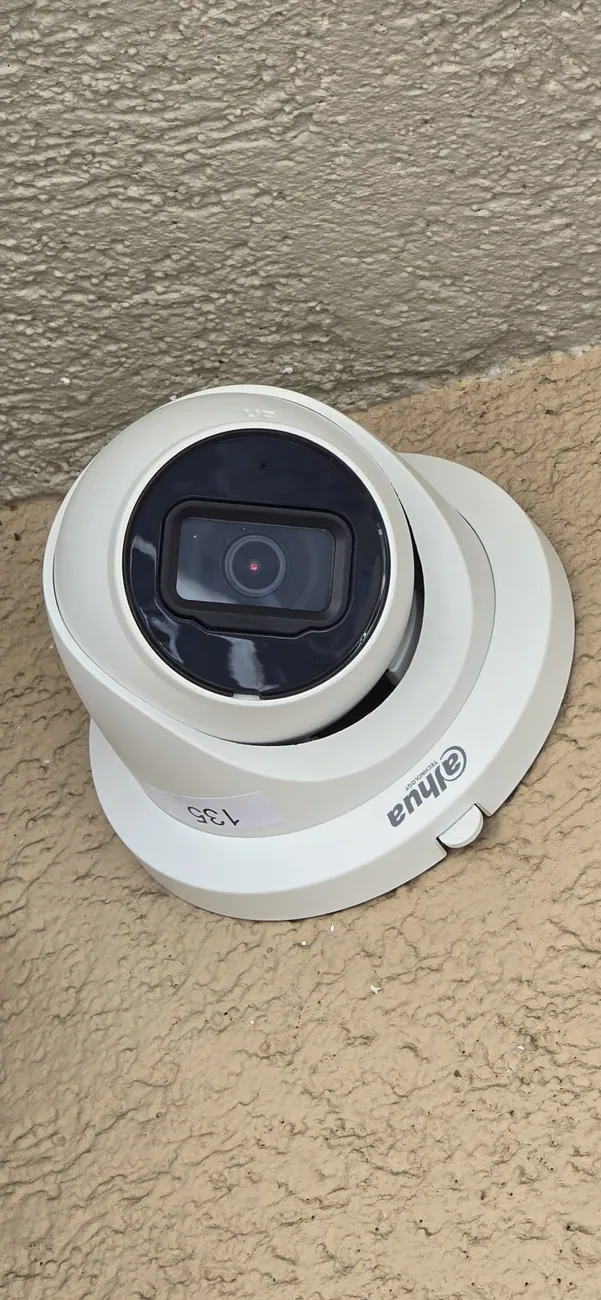 Turret camera installed on a stucco exterior wall